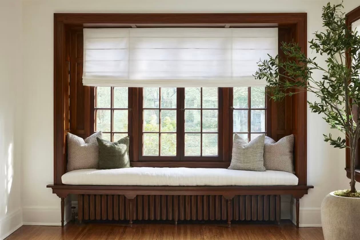 Elegant living room with custom shades and drapery installed
